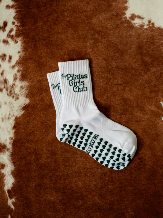 TCC ‘The Pilates Girl Club’ Grip Socks – green jacquard text with dark green heart grippies. One-size-fits-all, perfect for Pilates, barre, or yoga