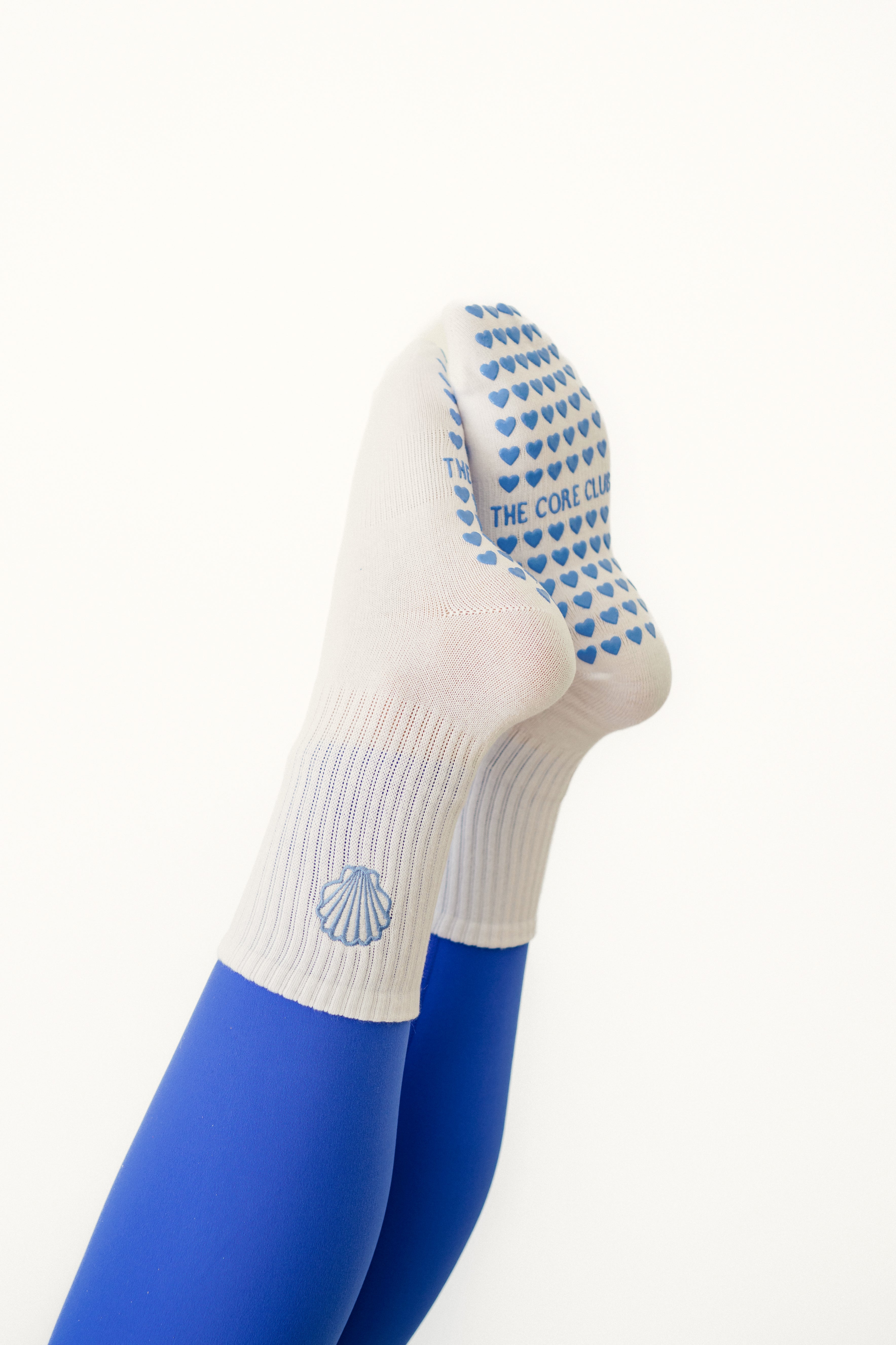 Seashell Grip Pilates Sock – white cotton non-slip socks with blue seashell detail & heart grippies. Unisex, one-size, perfect for Pilates, yoga & barre.